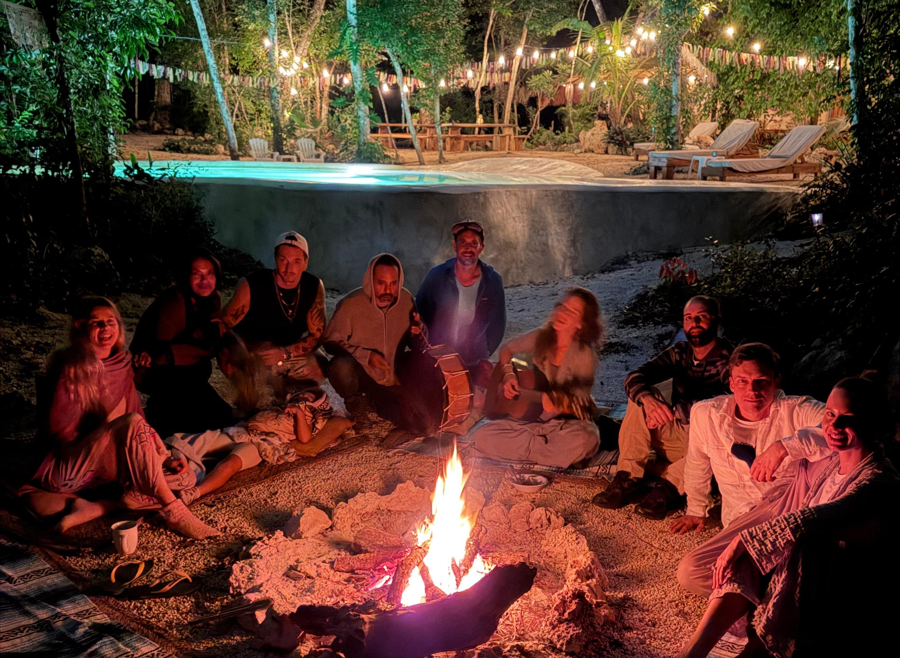 Fire circle ceremony with guests and pool at Casa Arkaana